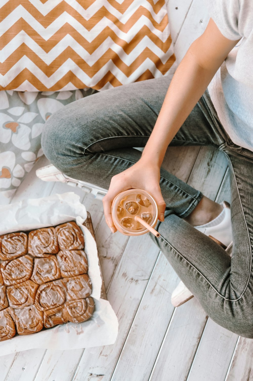 person holding drinking glass with straw