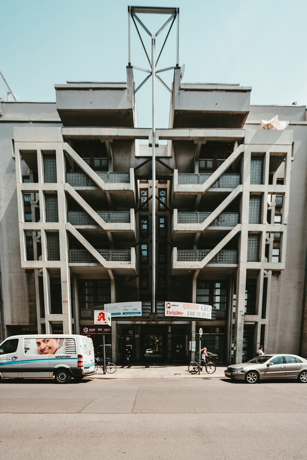 two cars parked in front of building