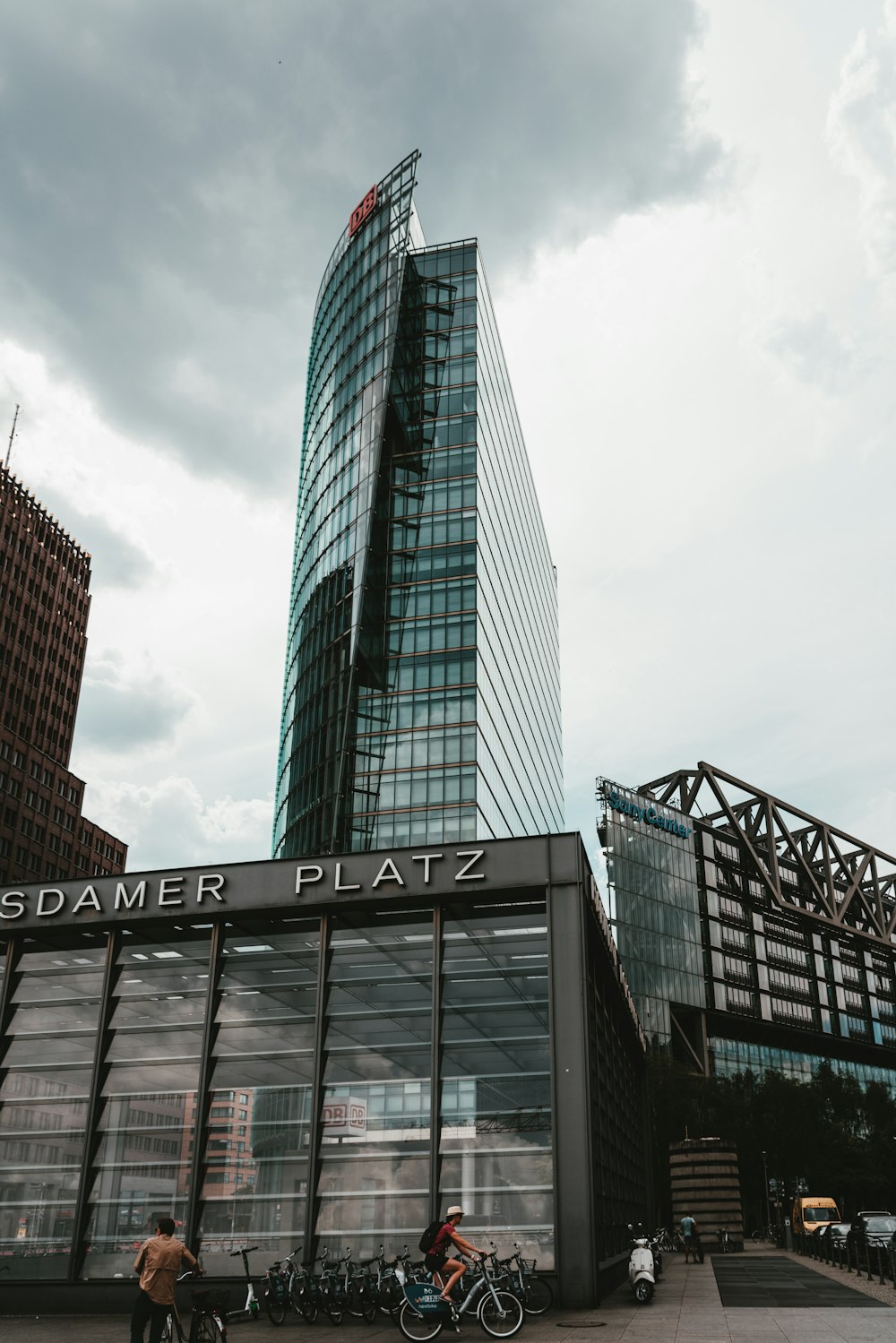 glass high rise building under white skies during daytime