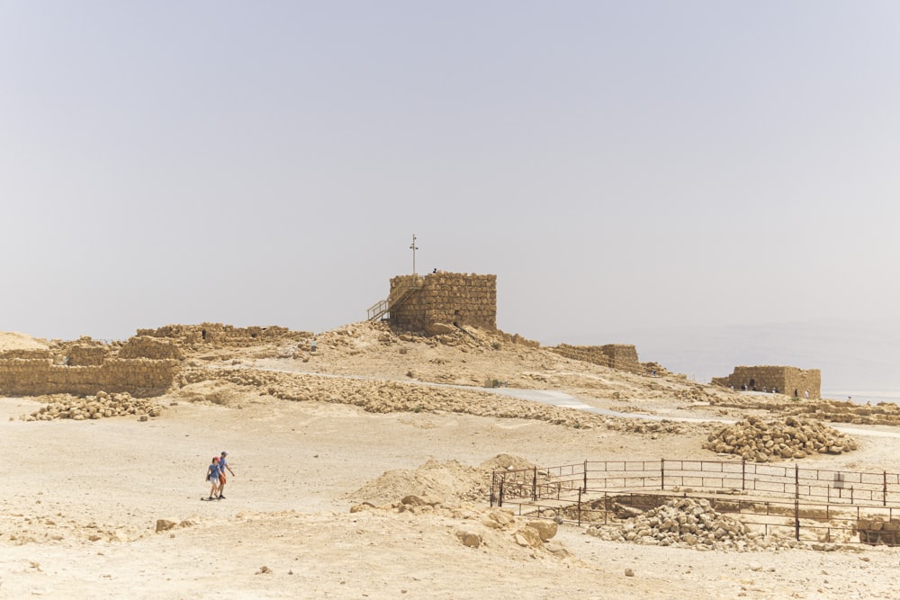 person walking on sand during daytime