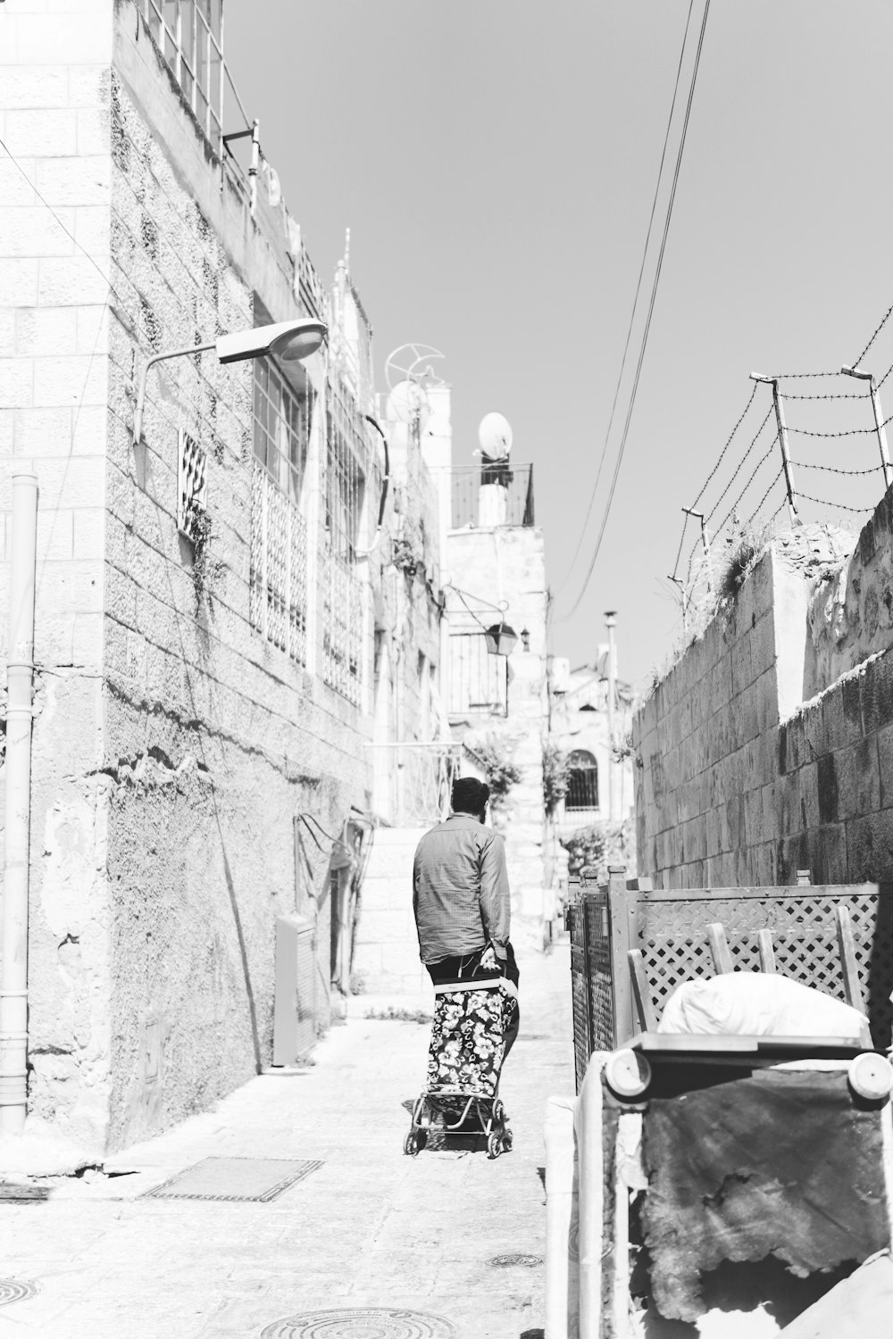 man on walkway in grayscale photo