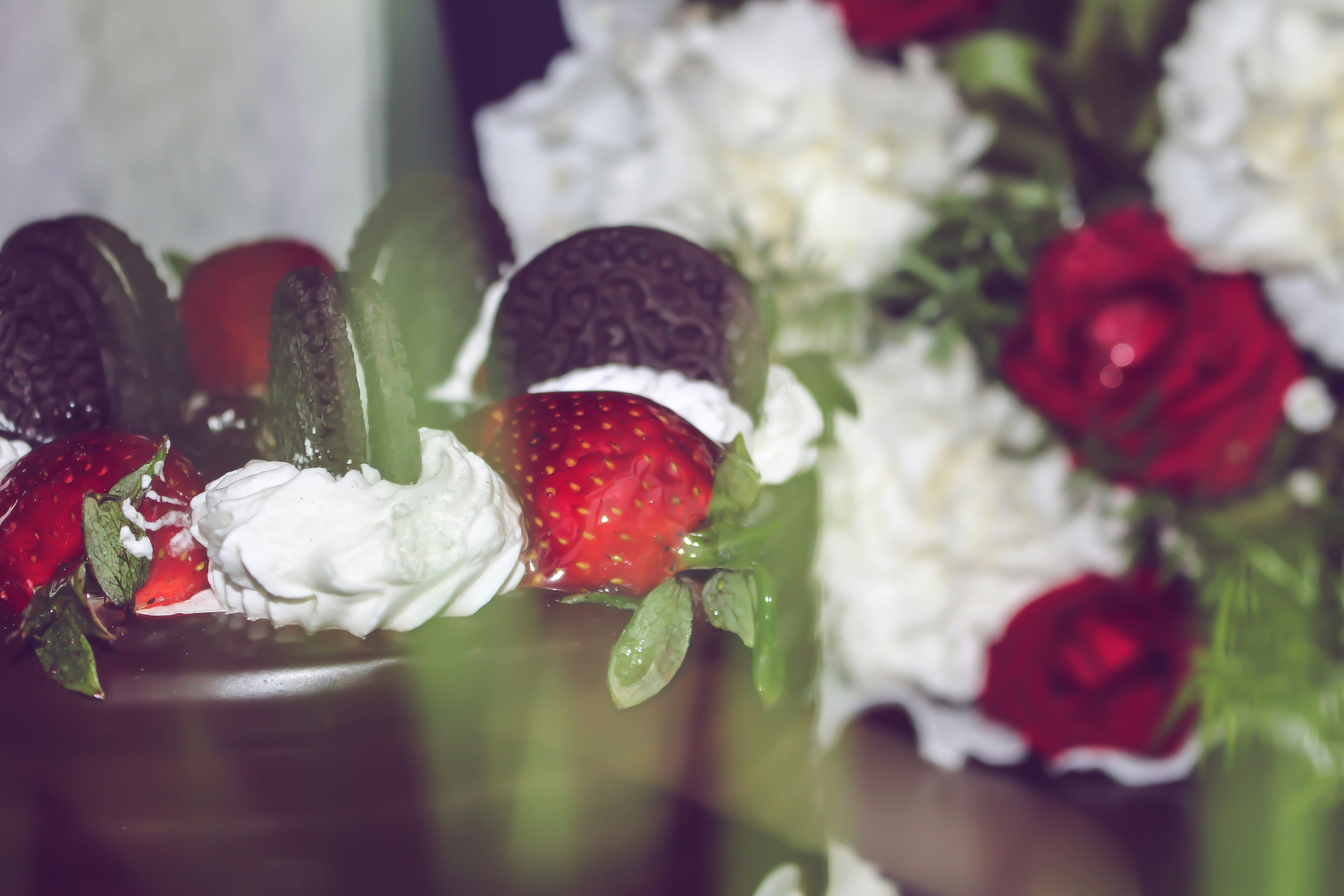 Strawberries and cream with red roses