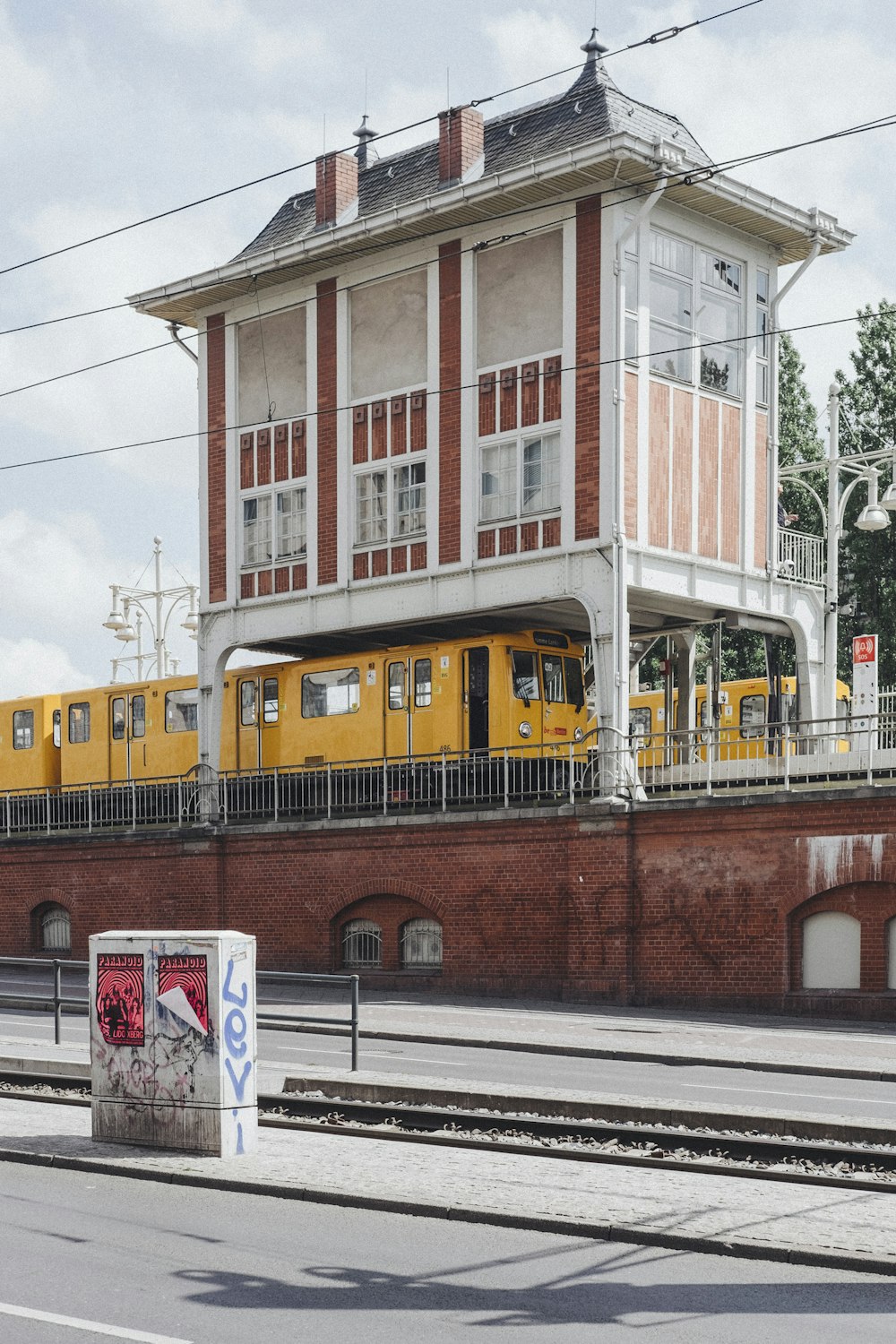 two yellow trains on railroad during daytime