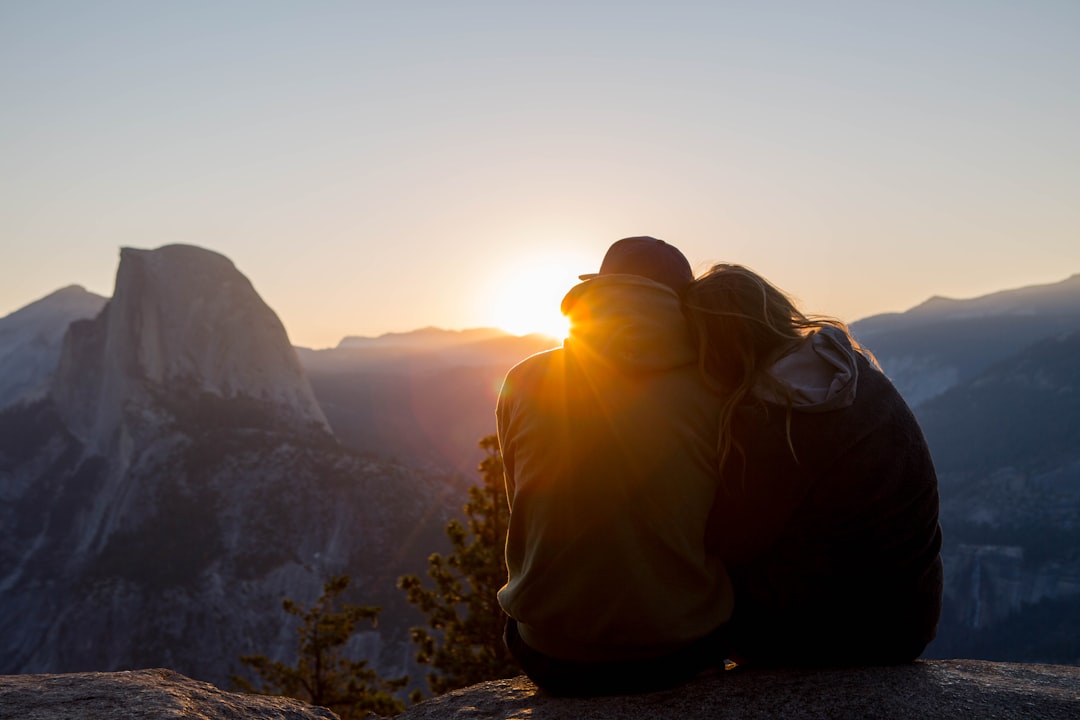 couple seated on rock formation