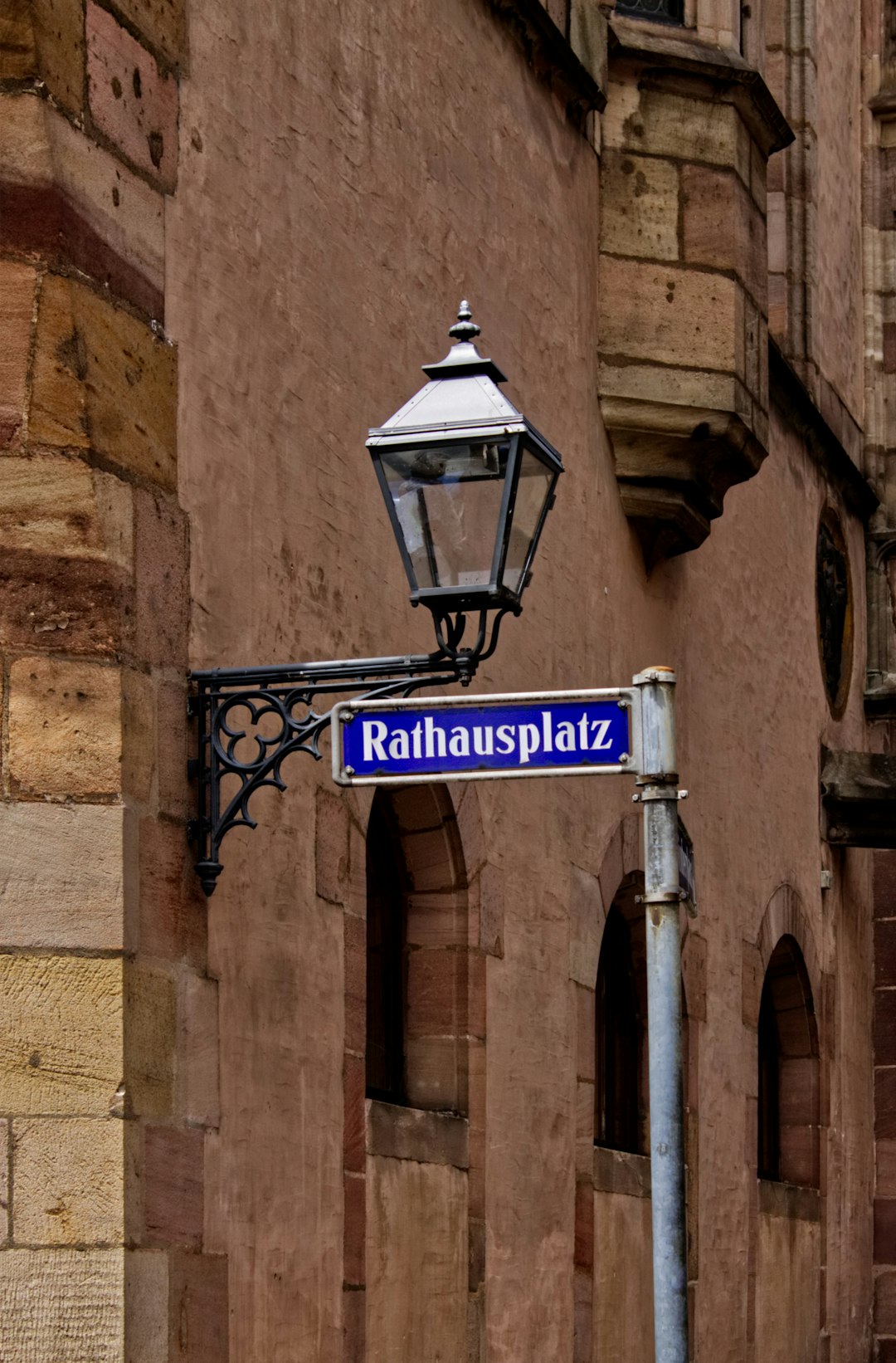 outdoor sconce with Rathausplatz signage