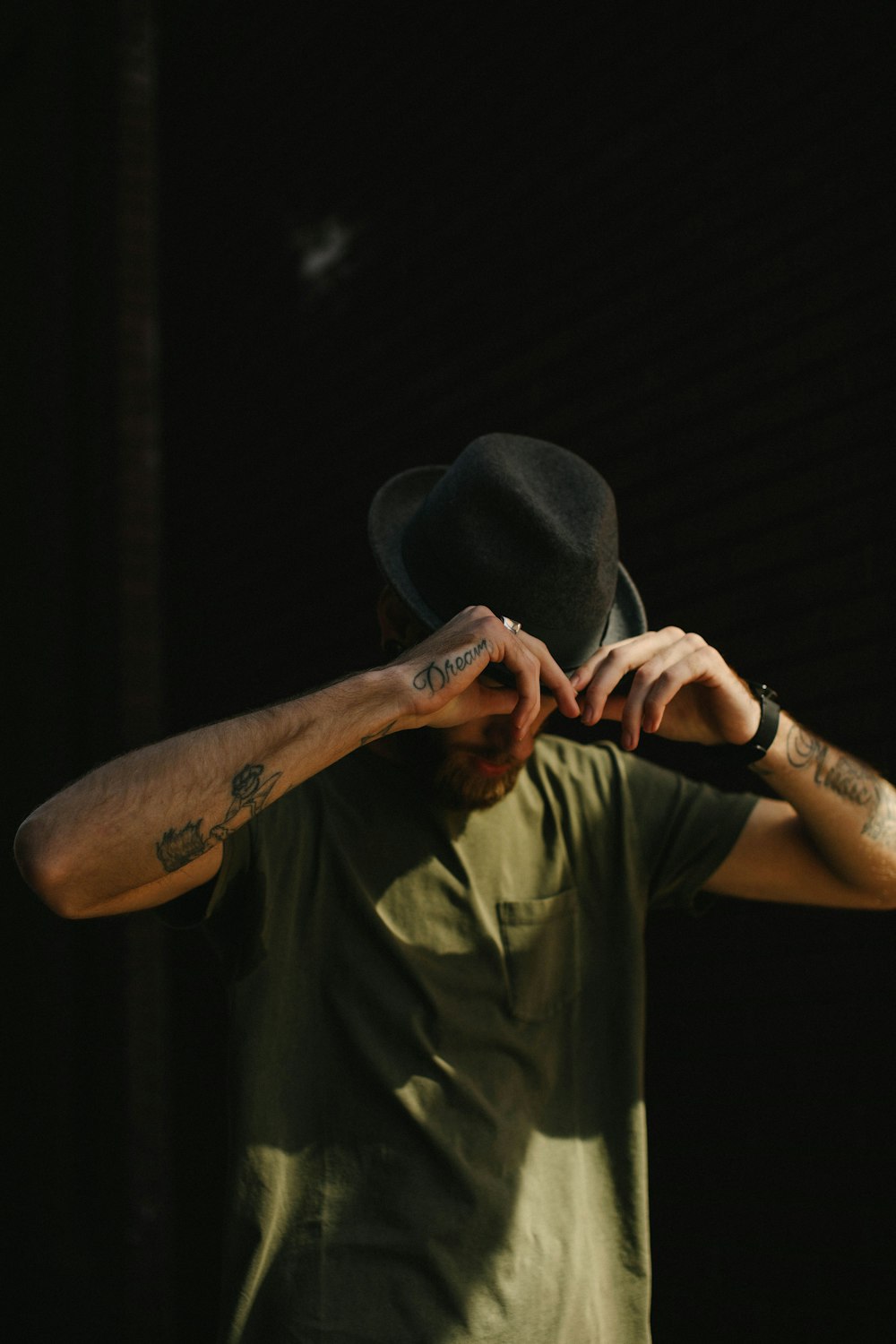 man holding his hat