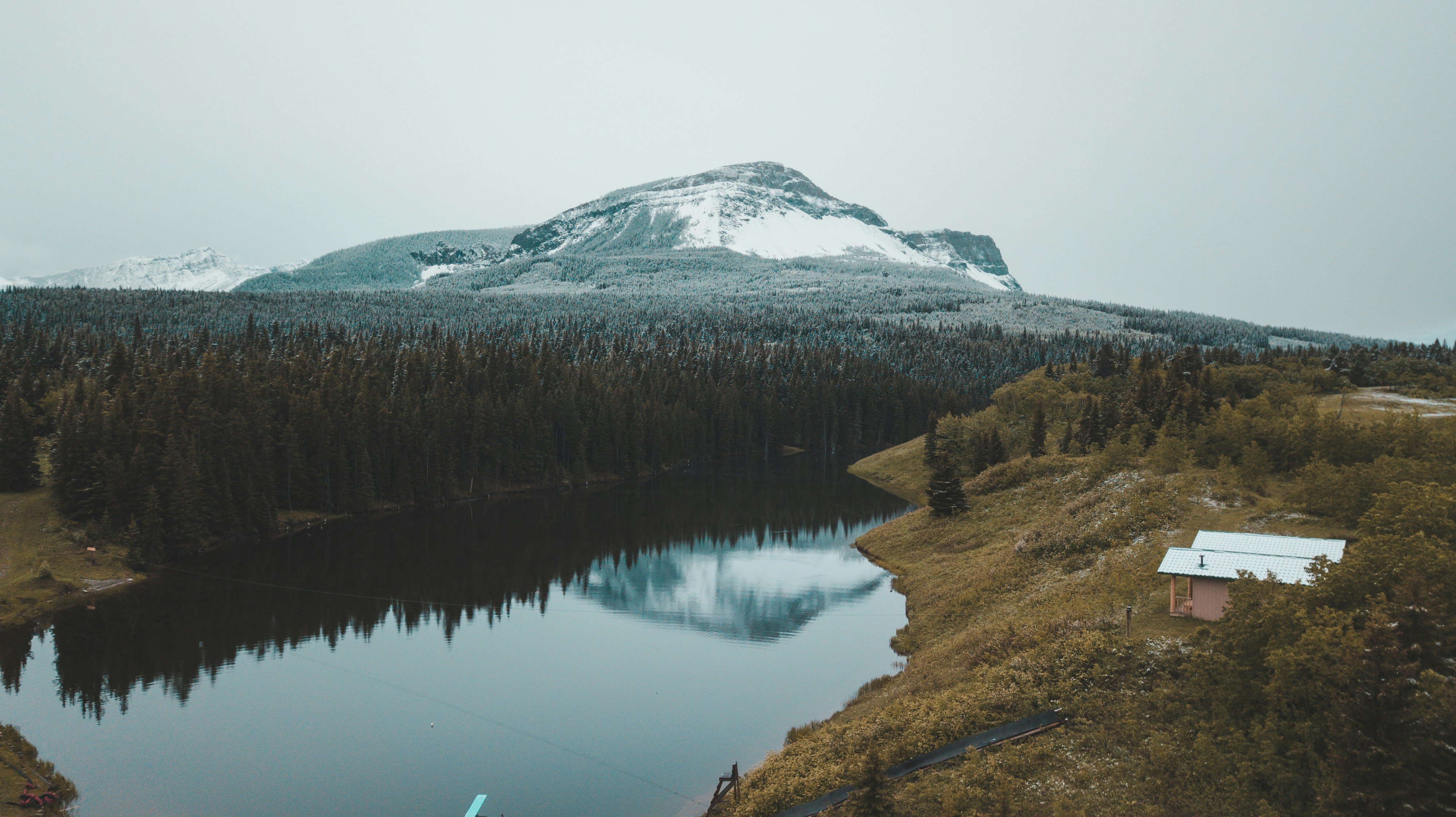 brown cottage on top of hill in riverbank