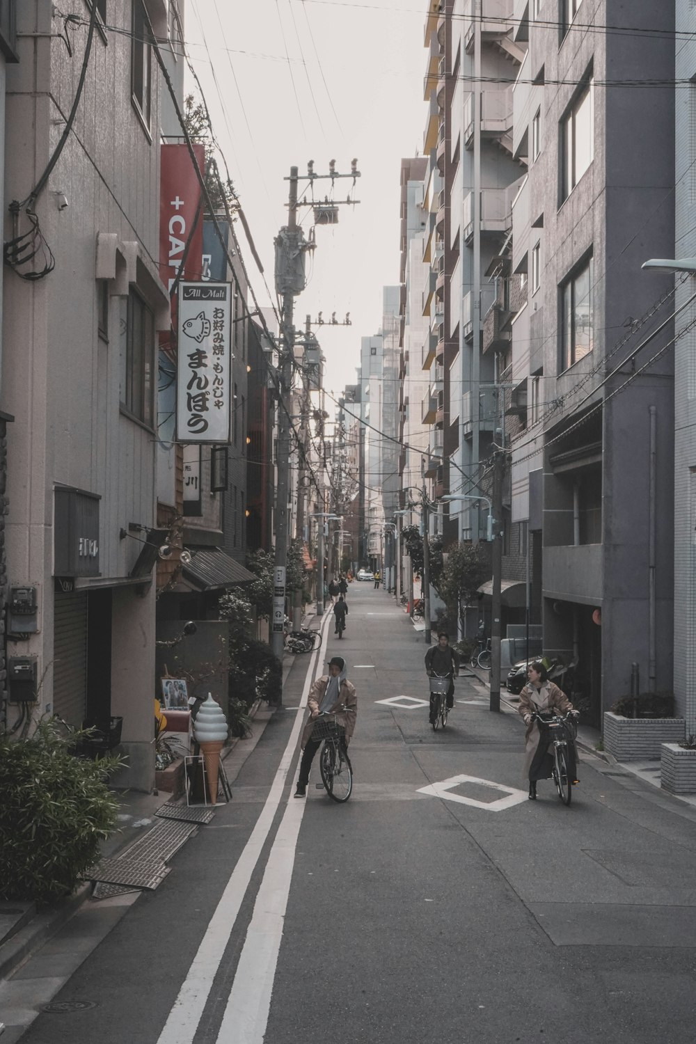 people riding on bicycle near buildings