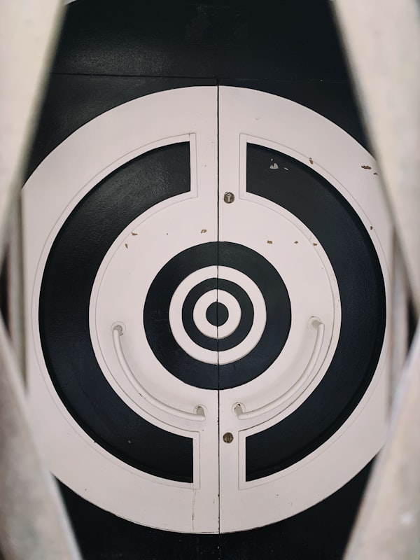 Circle bullseye target with shot grouping in the center