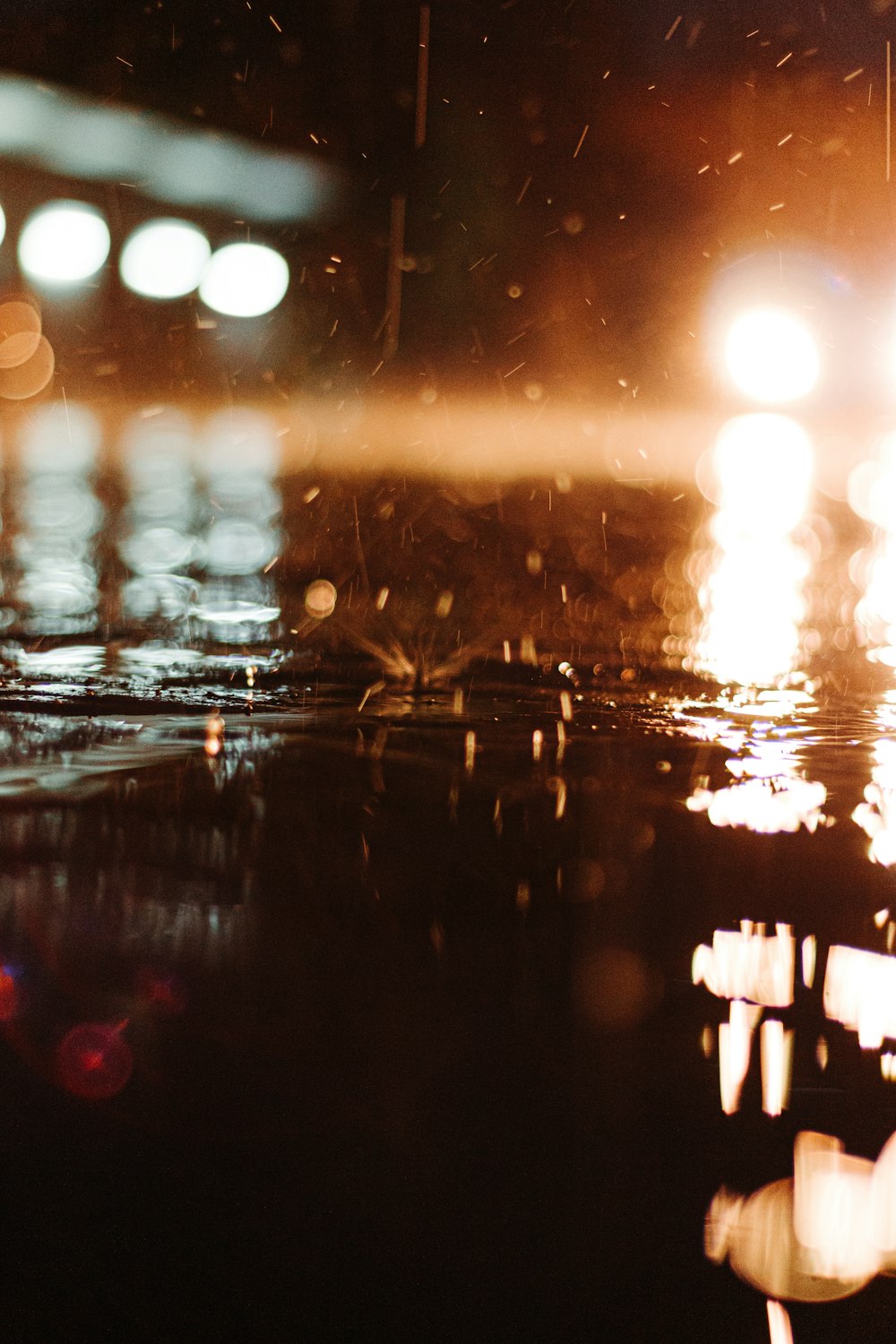 raindrops on a cement road at night