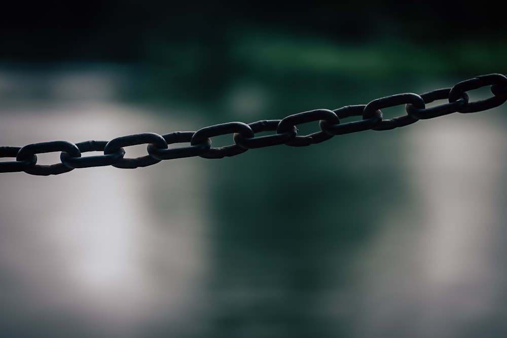 selective focus photography of gray metal chain