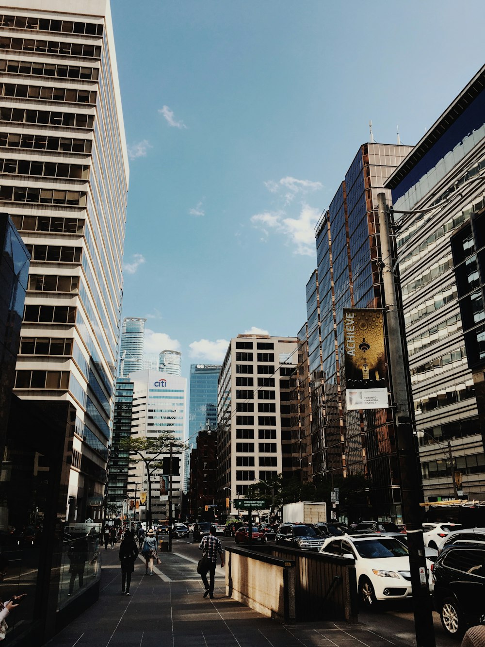 people and cars in busy city street