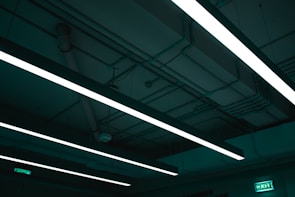 UV flame detector mounted on a ceiling in a commercial kitchen environment.