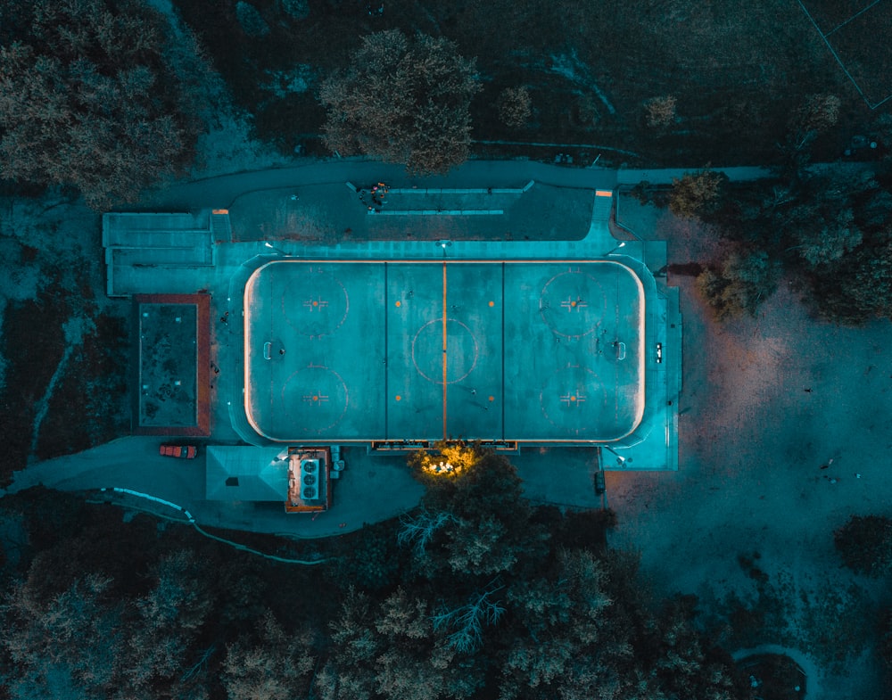 aerial photography of concrete building surrounded by trees
