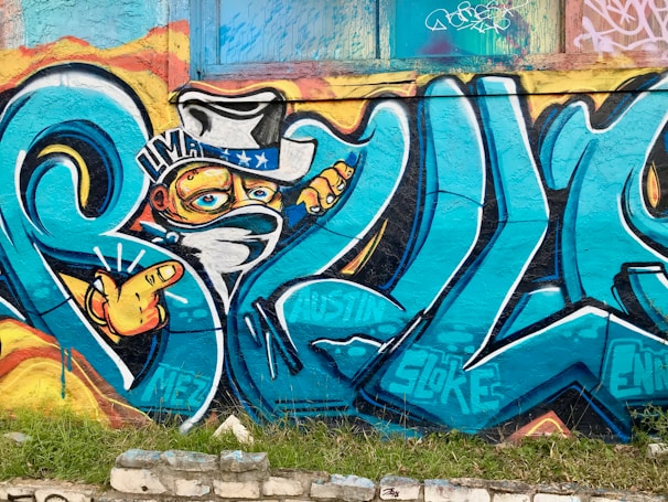 A dynamic street art mural featuring the $wif hat and the phrase 'the hat stays on' in bold colors.