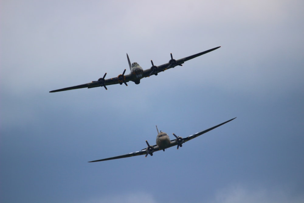 two gray airplanes in air during daytime