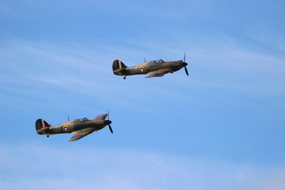 two green fighter planes flying