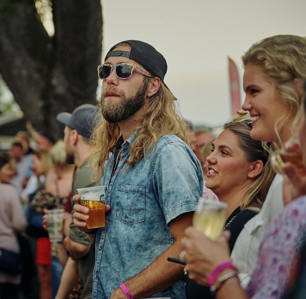 man holding cup of beer