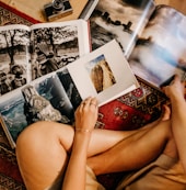 woman sitting on floor reading books