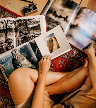 woman sitting on floor reading books