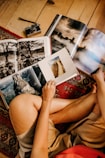 woman sitting on floor reading books