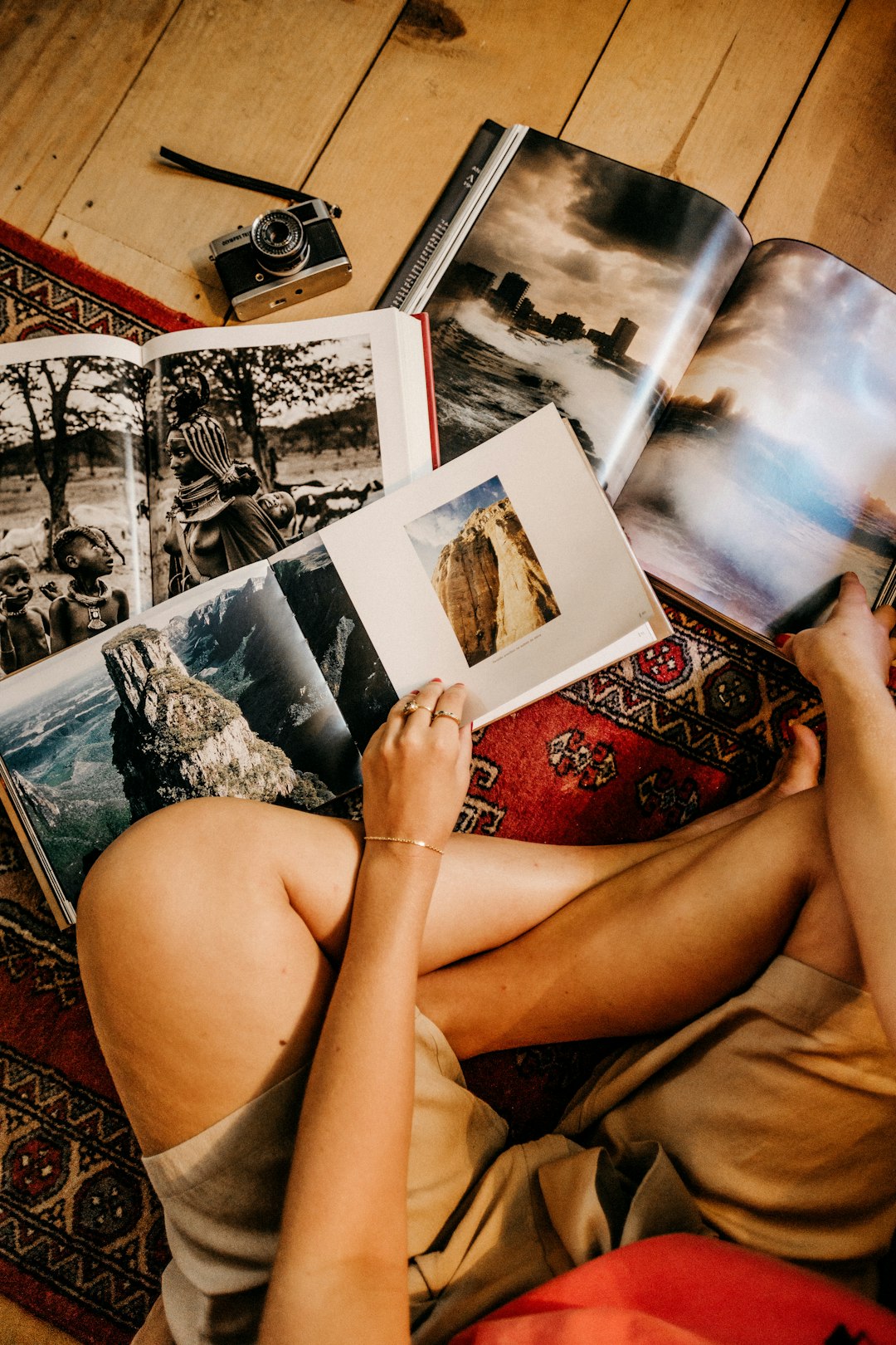 woman sitting on floor reading books