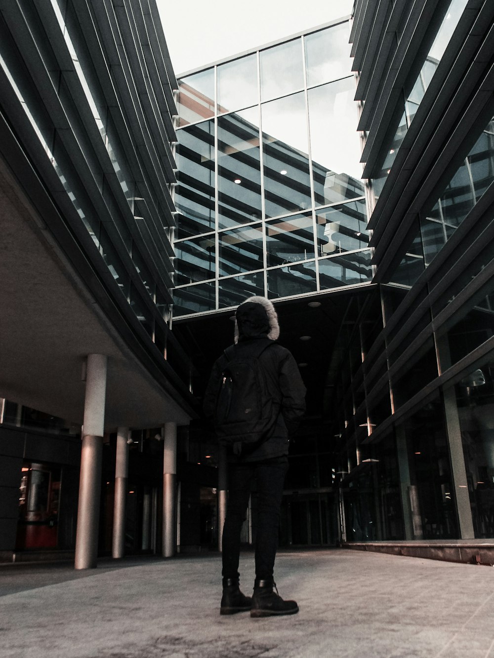 standing man looking up inside building