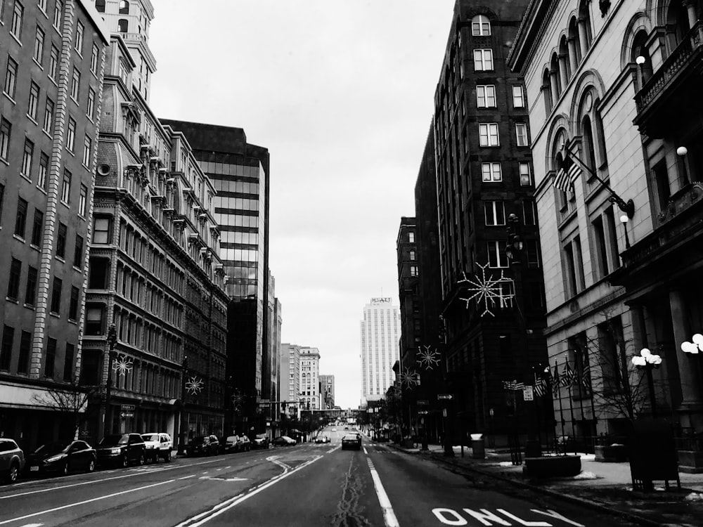 grayscale photo of vehicles on road