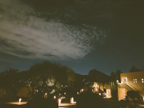 Evening shot of the resort illuminated against a backdrop of mountain silhouettes.
