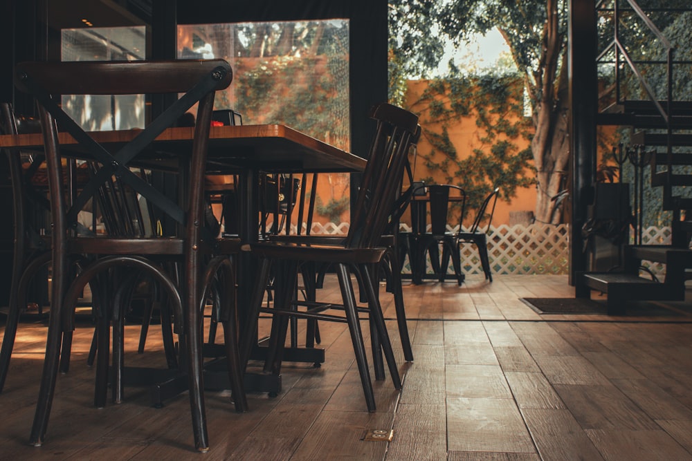 black and brown wooden tables and chairs in a restaurant