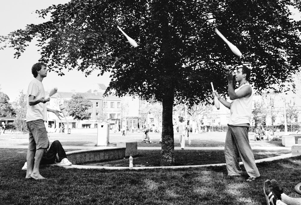 grayscale photo of two jugglers