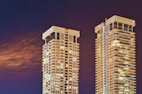 two white high-rise buildings at night time