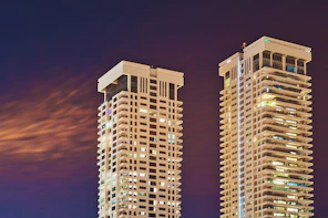 two white high-rise buildings at night time