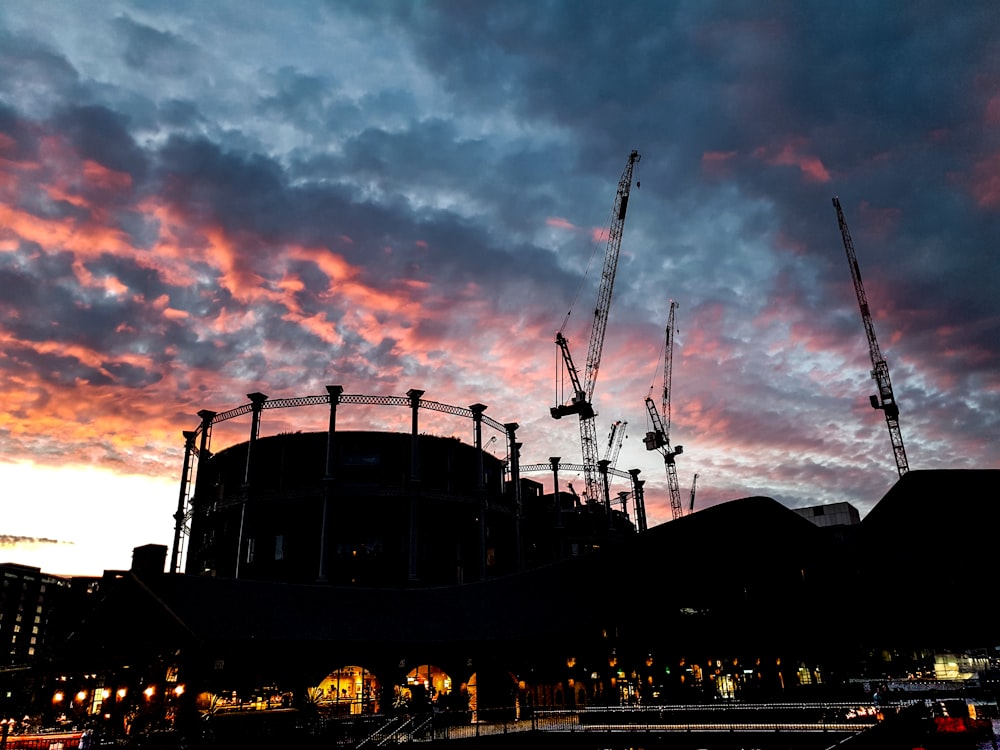 high-rise buildings showing industrial crane under blue and orange skies