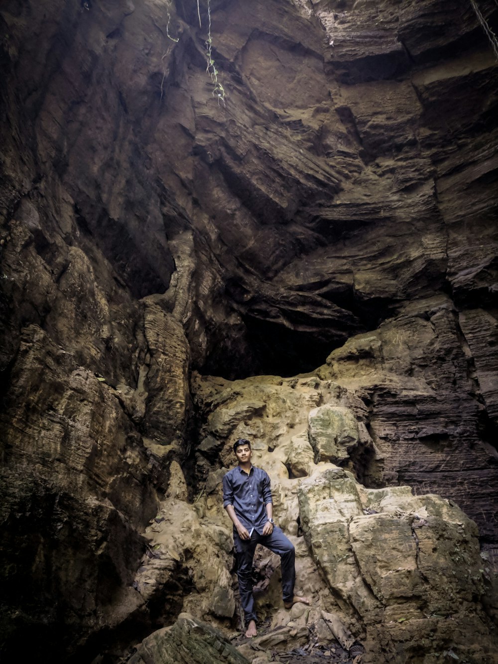 man standing inside cave