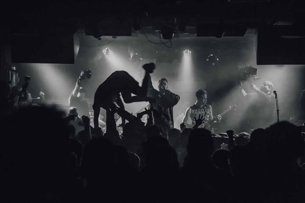 grayscale photography of group of male performing on stage