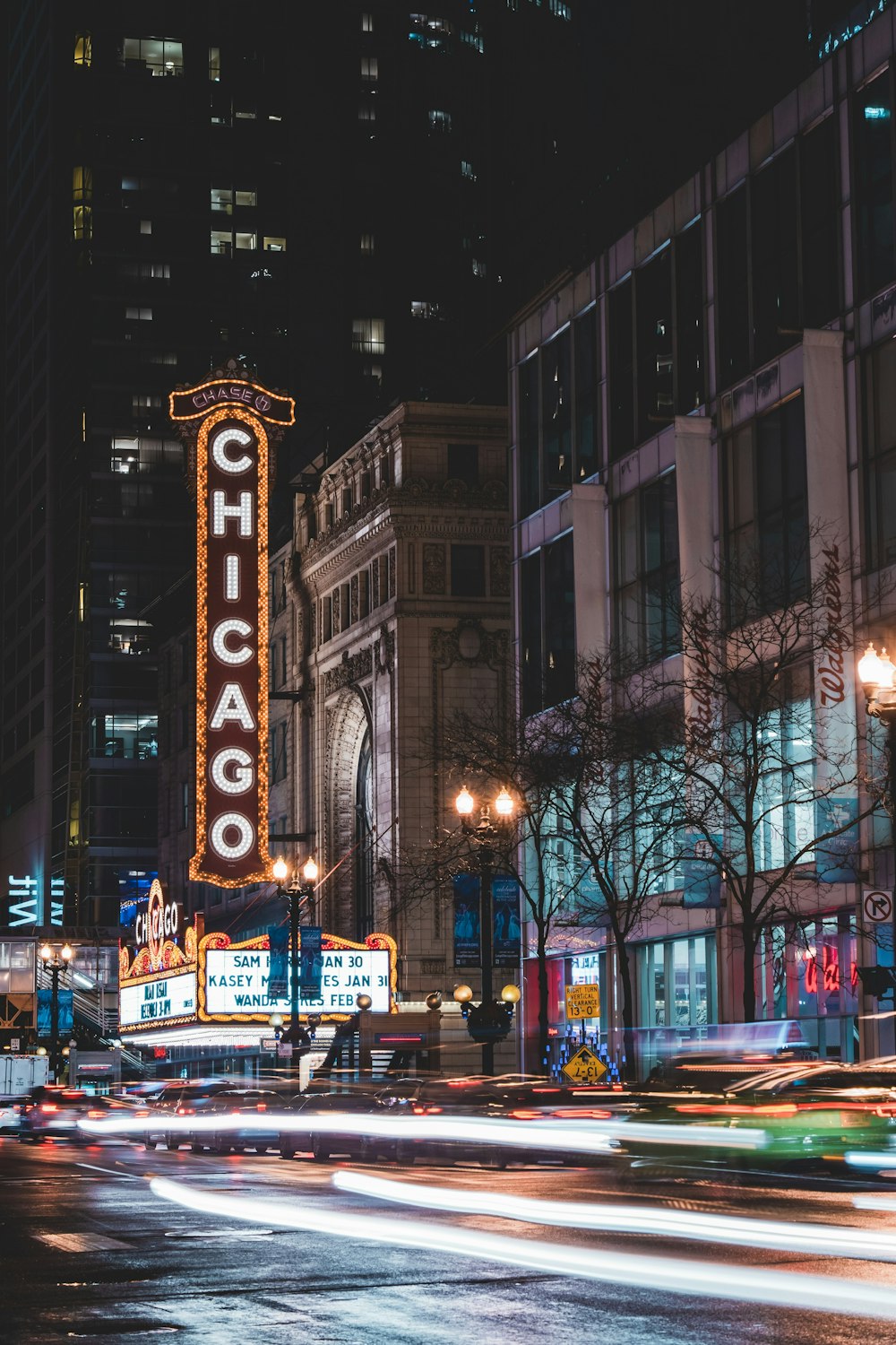 time lapse photo of cars passing by buildings during nighttime