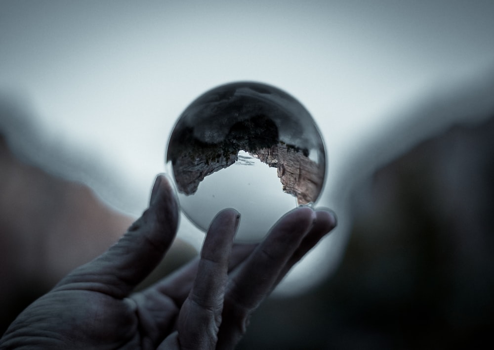 reflection of landscape in clear glass ball