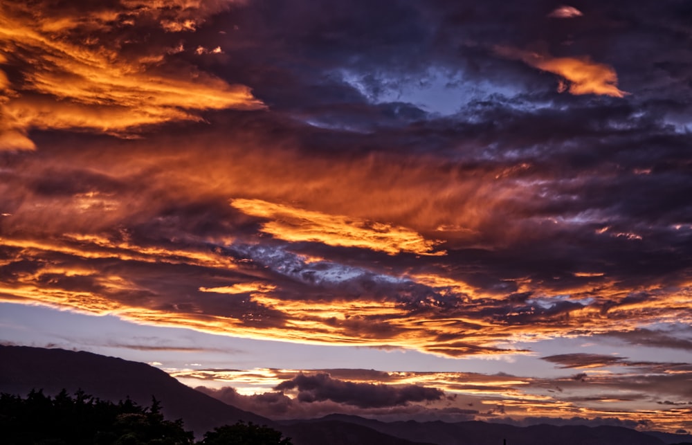 red and black clouds during golden hour