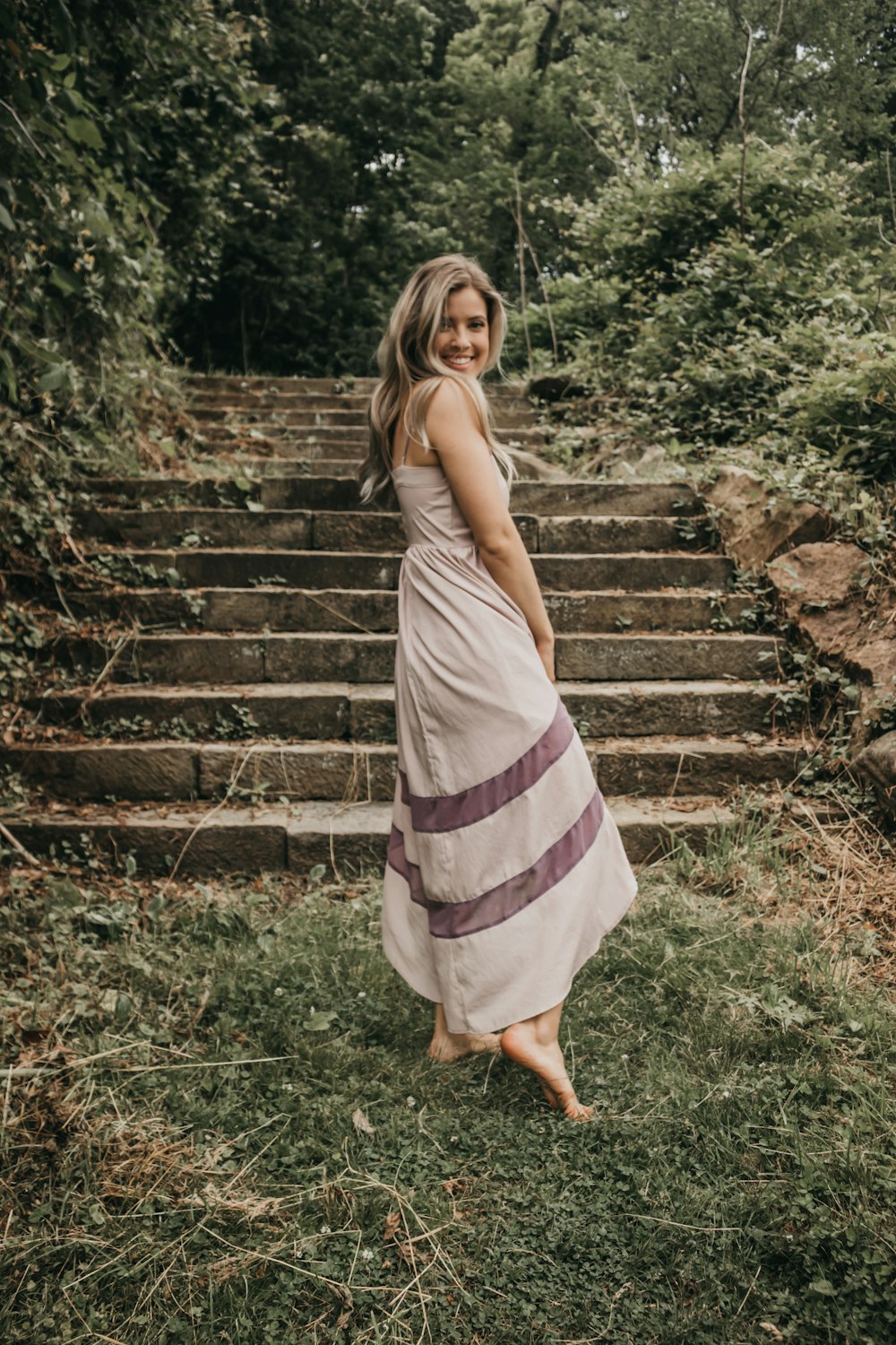 woman in gray walking towards the stairs