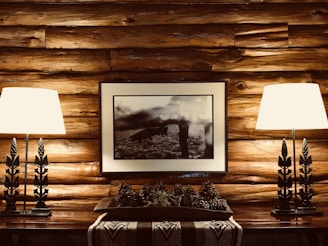 A light gray standing dead pine ladder displaying a colorful patchwork quilt in a cozy cabin corner.