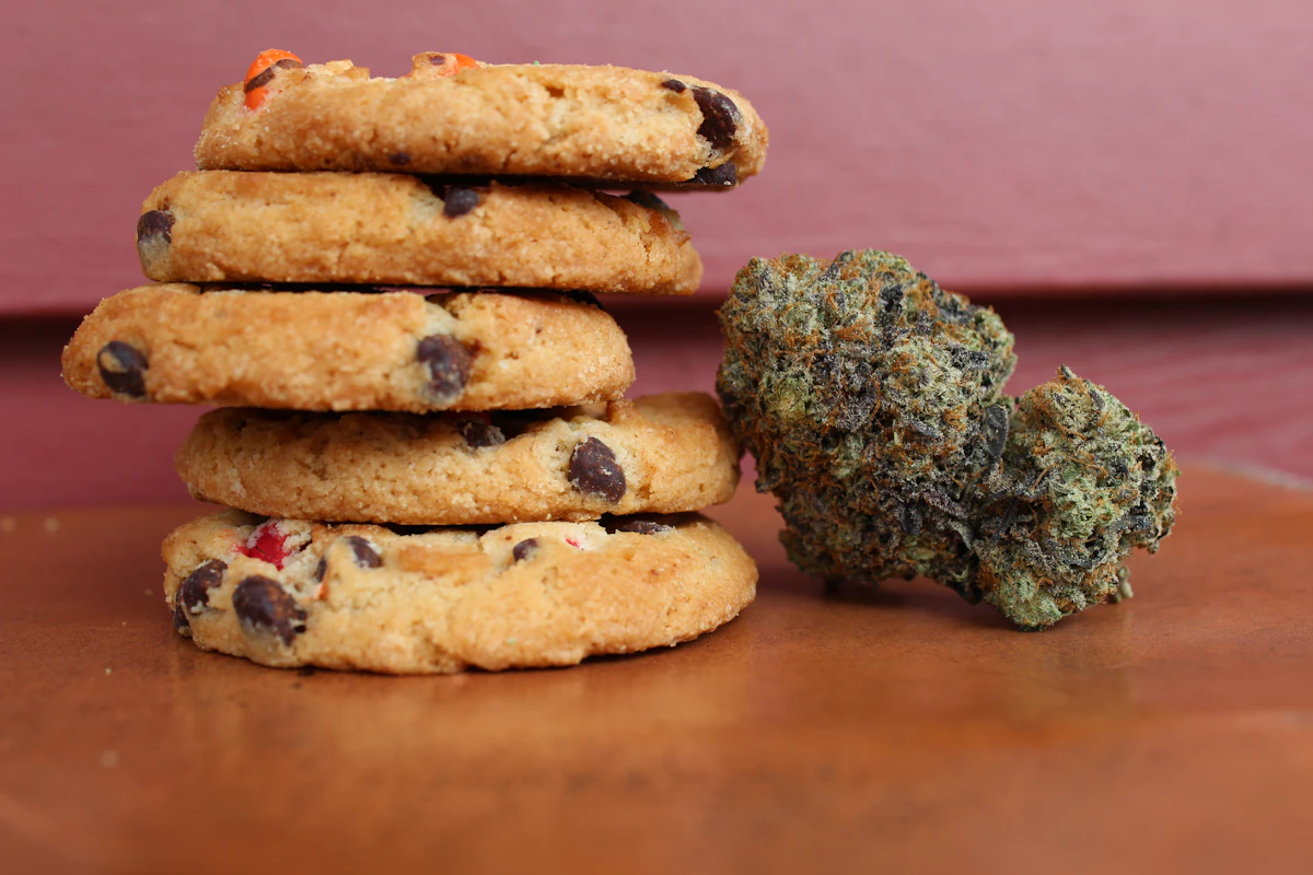 Cannabis infused cookies beside cannabis flower, showing how edibles deliver THC through digestion