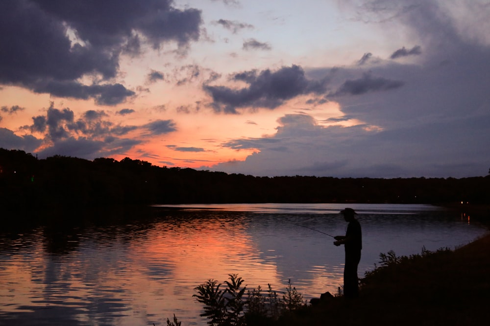landscape photo of a fisherman at sunset