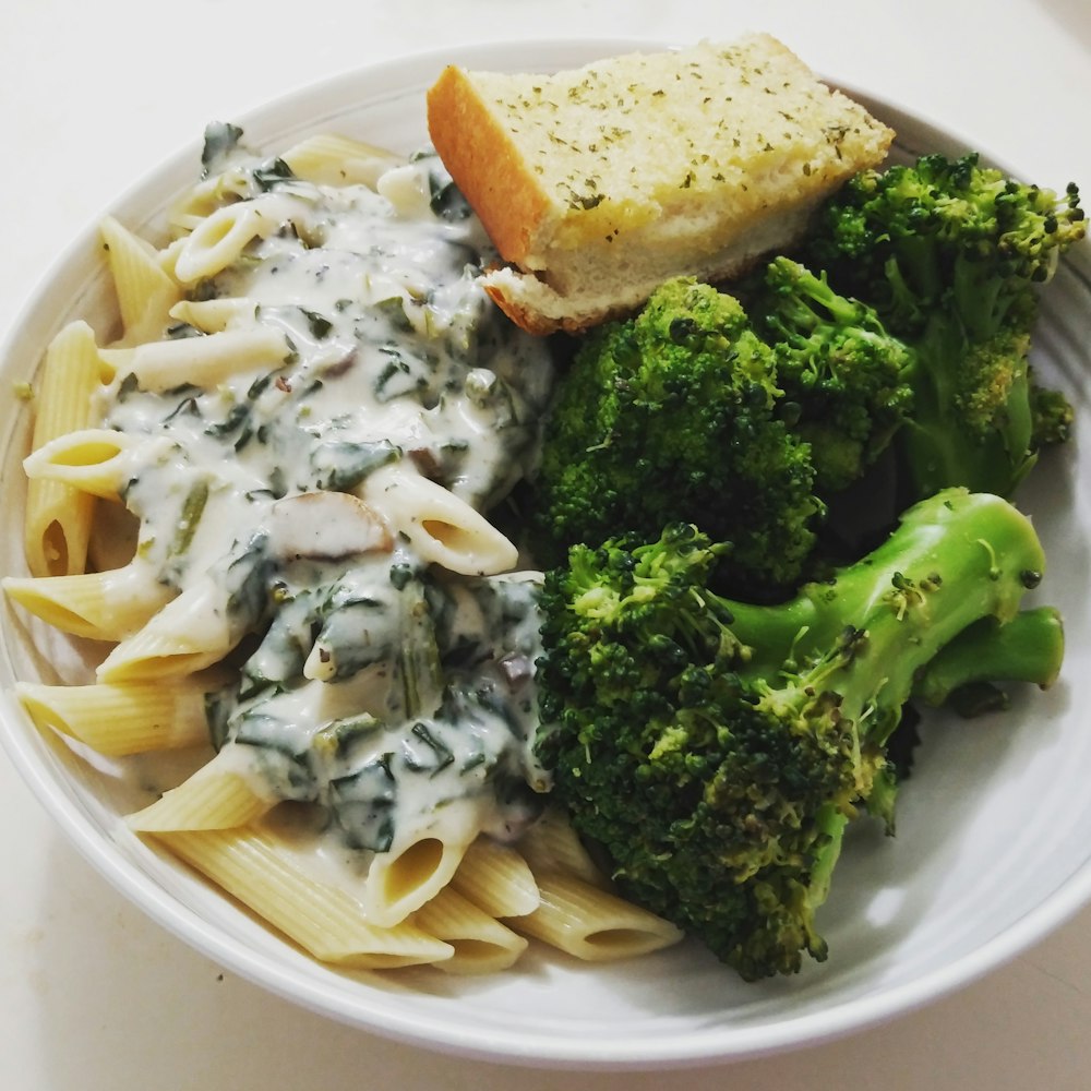 bread, pasta and broccoli in plate