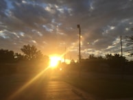 A golden sunrise casting light over a network of connected industries.