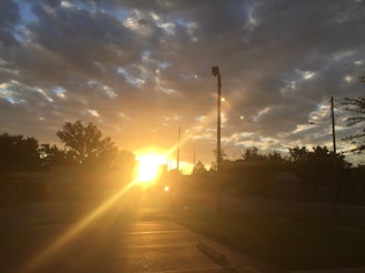A golden sunrise casting light over a network of connected industries.