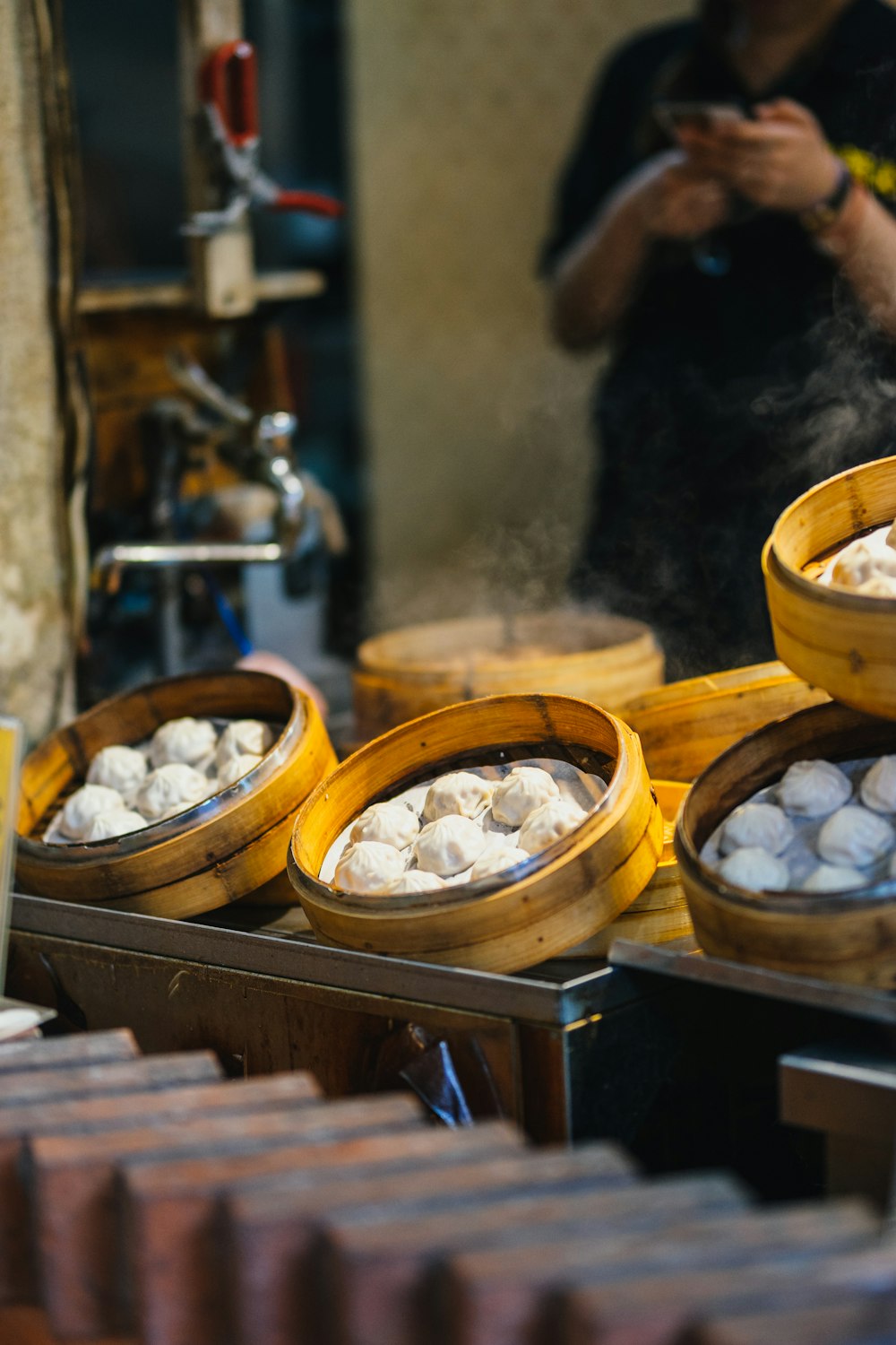 selective focus photography of bamboo steamer with pastry