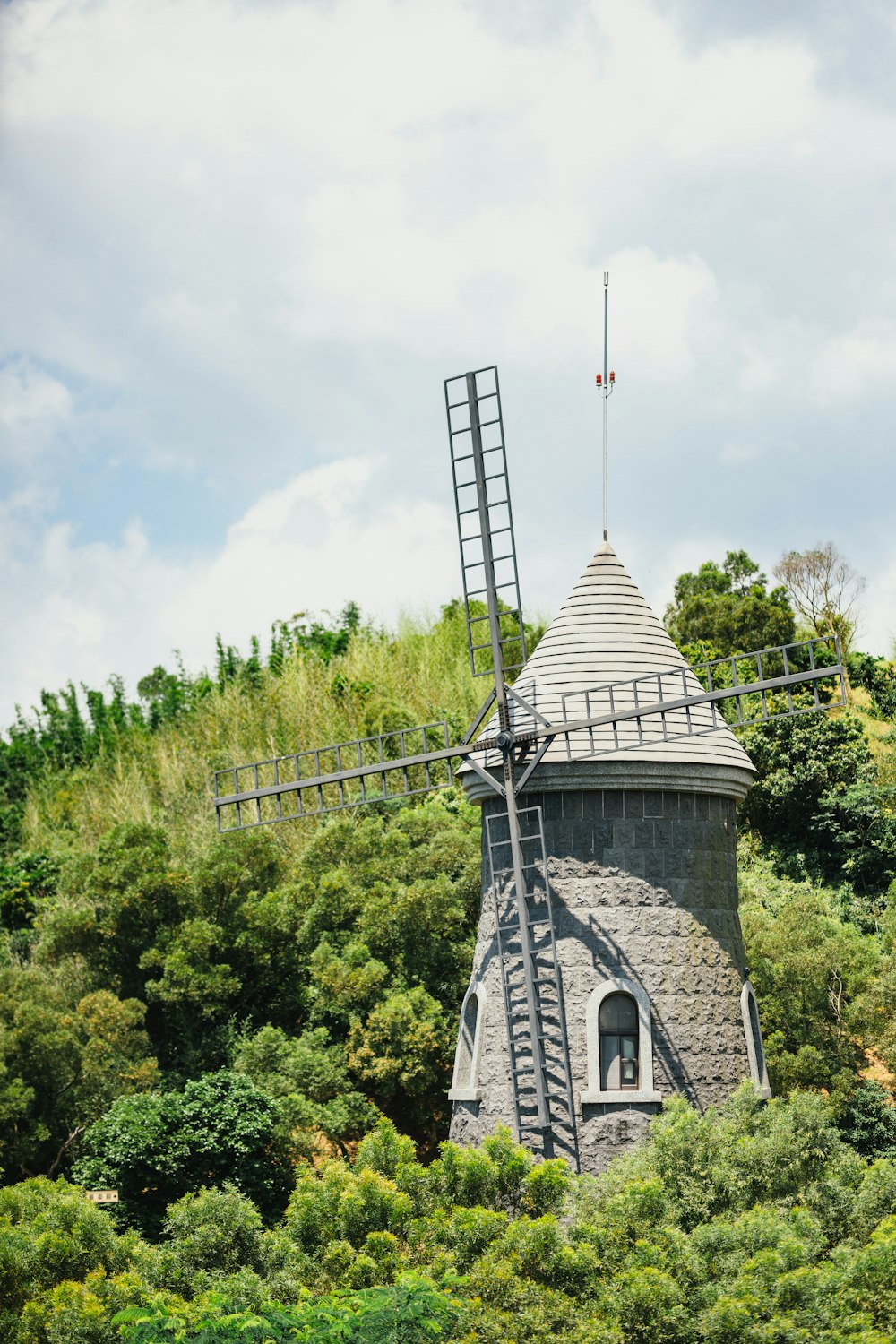 gray wind vane under white sky