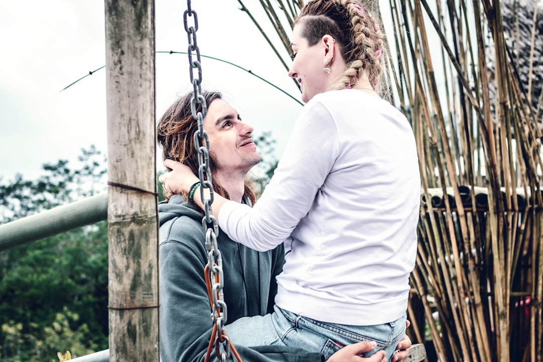 couple sitting face to face on swing