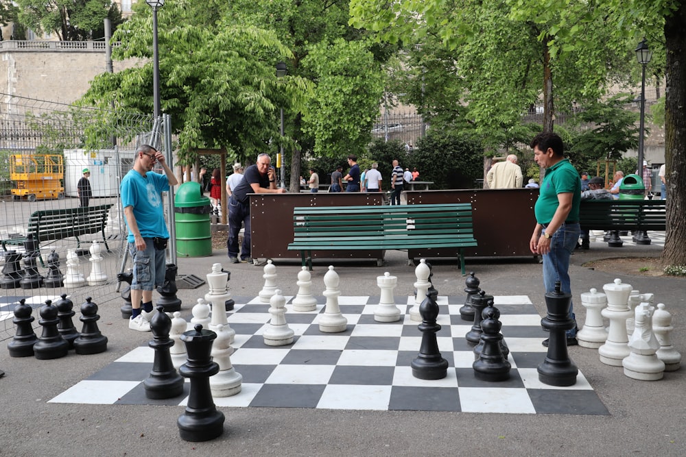 two men playing large chess pieces